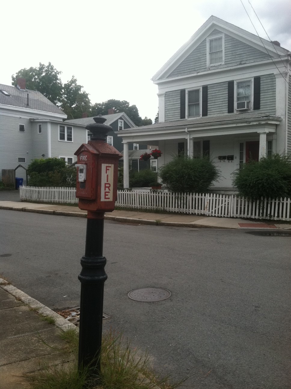 Vintage red fire alarm box on a residential street in Newton, Massachusetts